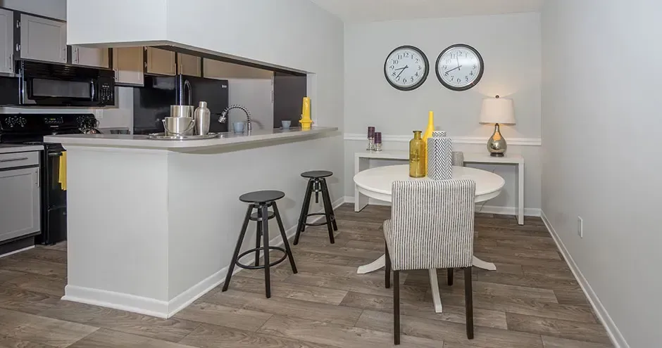 A dining room with a table and chairs in a kitchen at The Summit at Rock Hill in Rock Hill, SC.