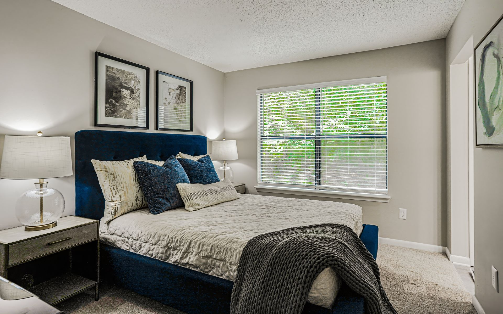 Swimming pool with lounge chairs, tables, and a clubhouse in the background.