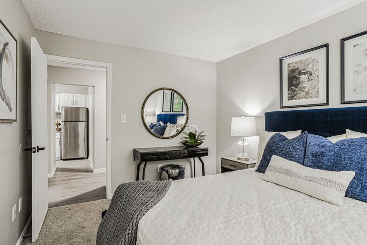 Cozy home office with a daybed, desk, and decorative closet doors. Soft colors and natural light.
