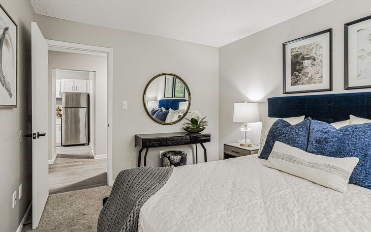 Cozy home office with a daybed, desk, and decorative closet doors. Soft colors and natural light.