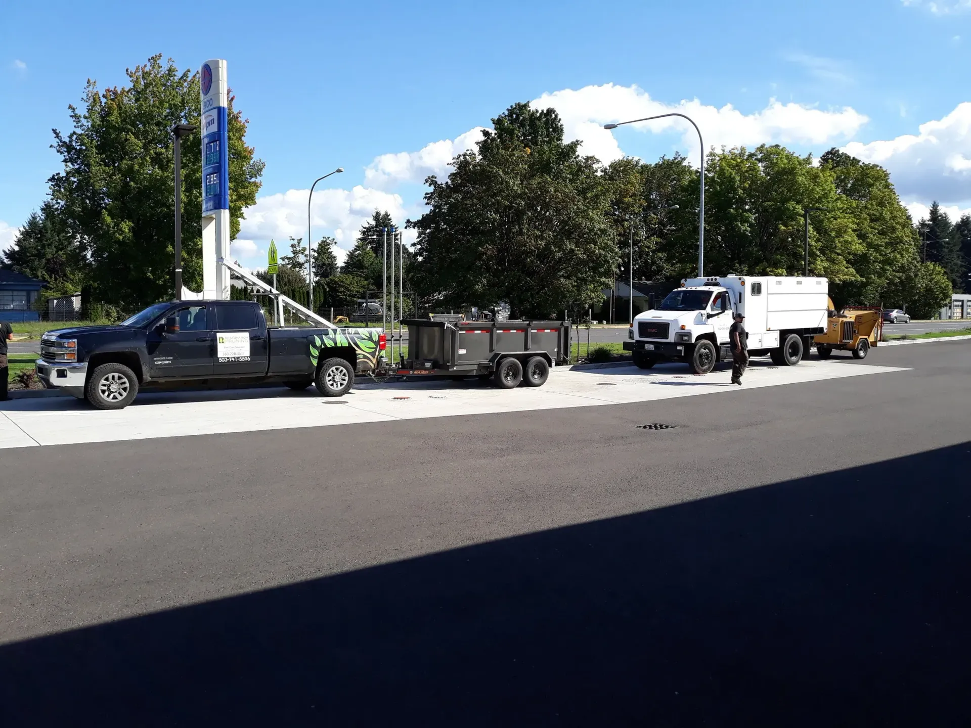 A row of trucks are parked on the side of the road