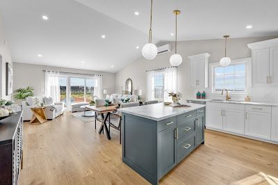 A kitchen with stainless steel appliances and a large table