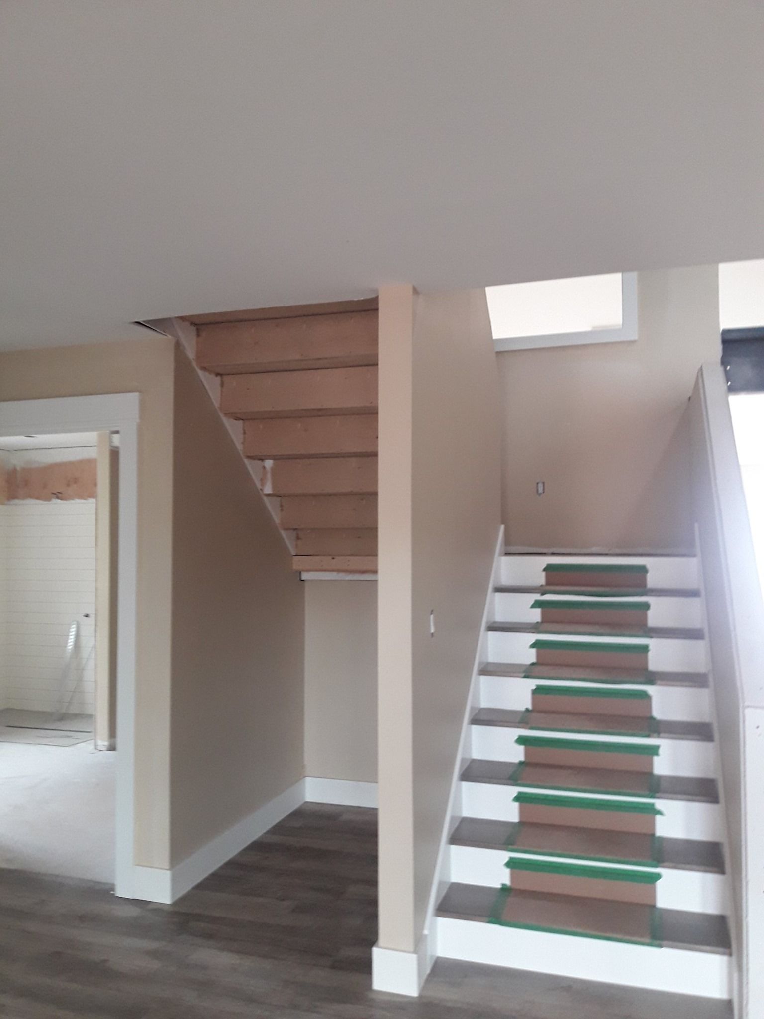 An empty room with stairs leading up to the second floor