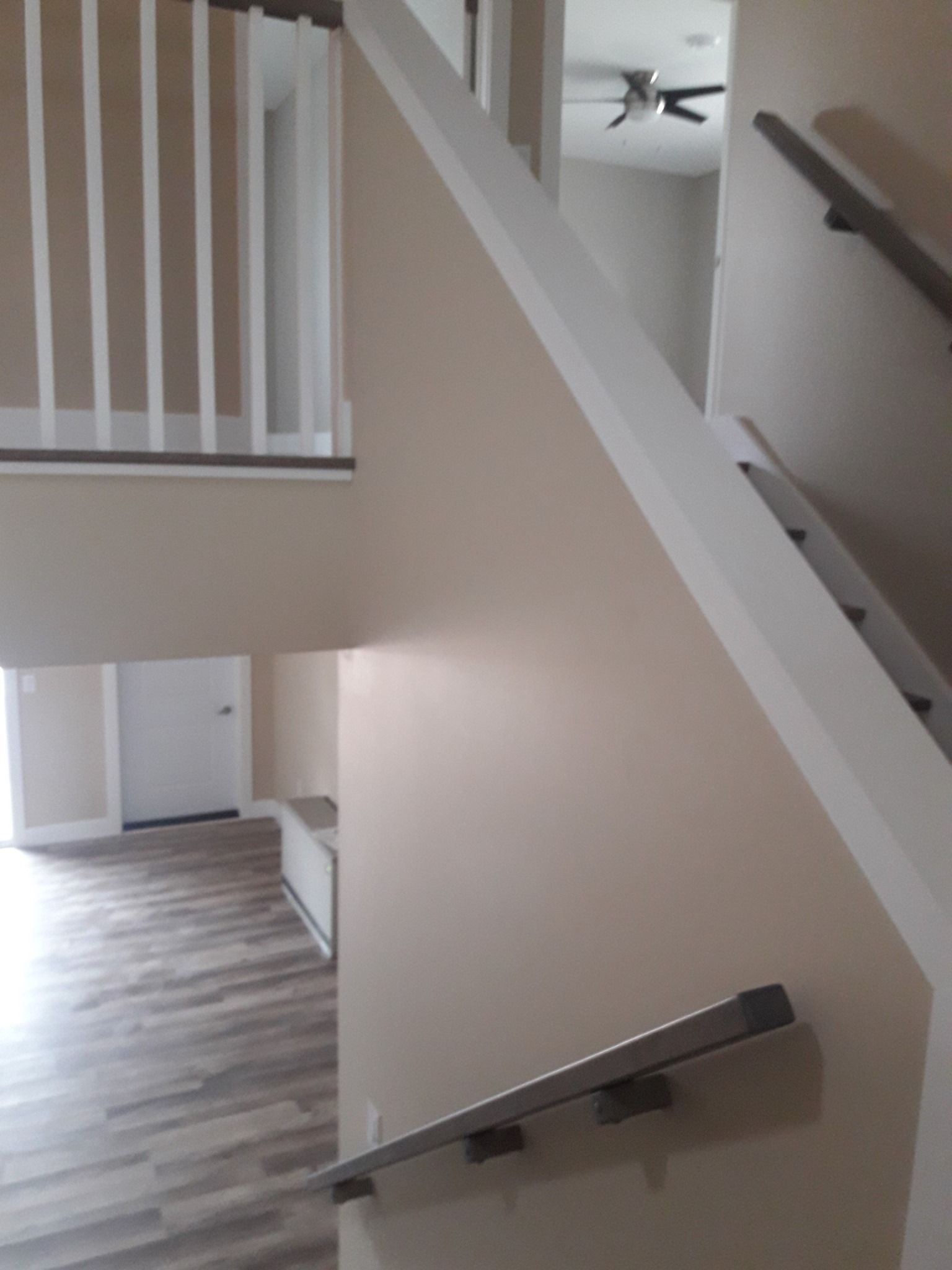 A view of a staircase from the second floor of a house.