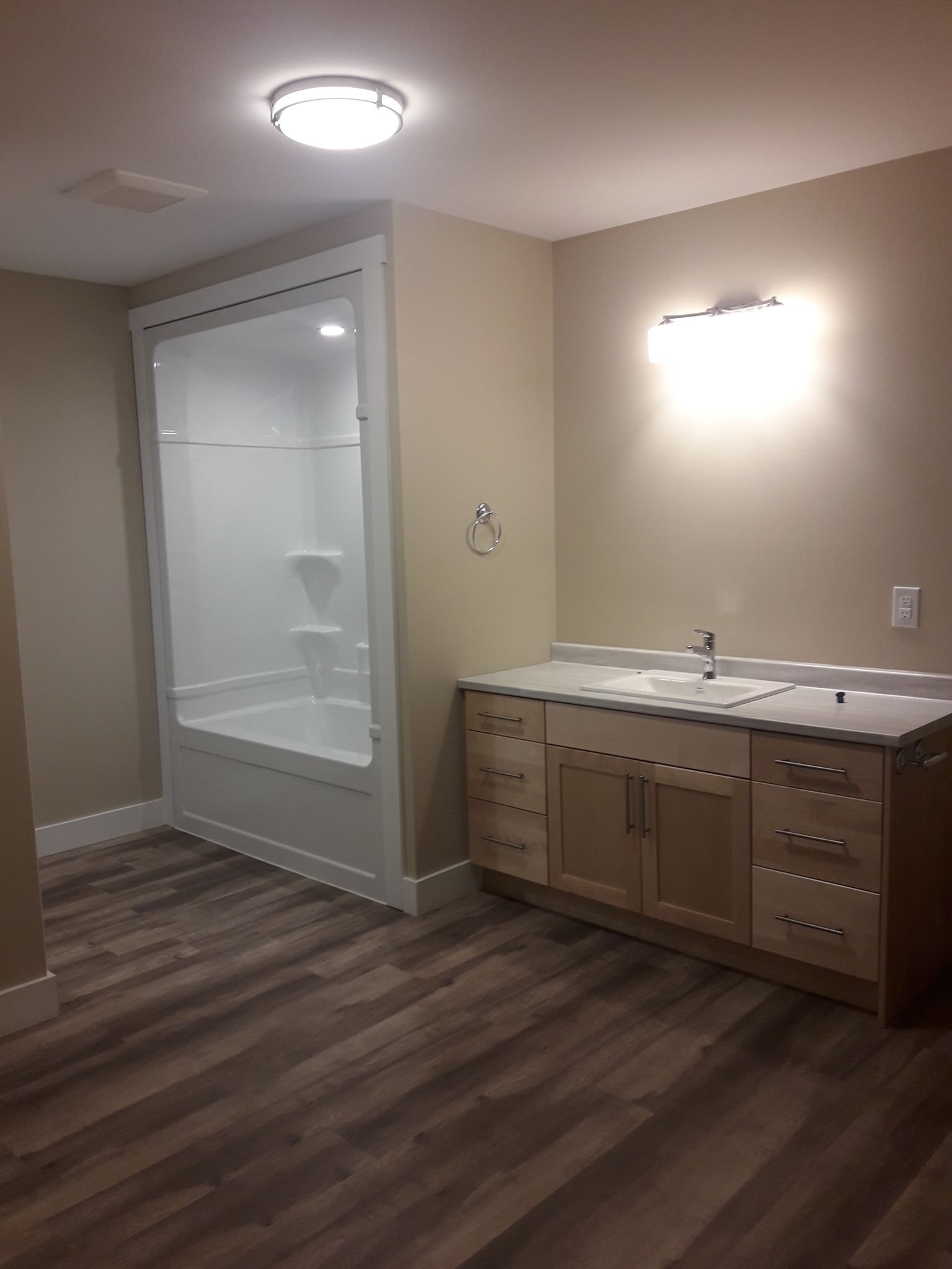 A bathroom with two sinks , a tub and a shower.