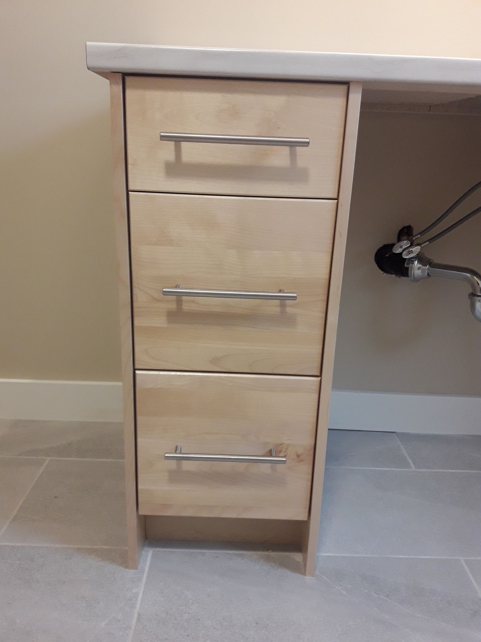 A wooden desk with three drawers underneath it