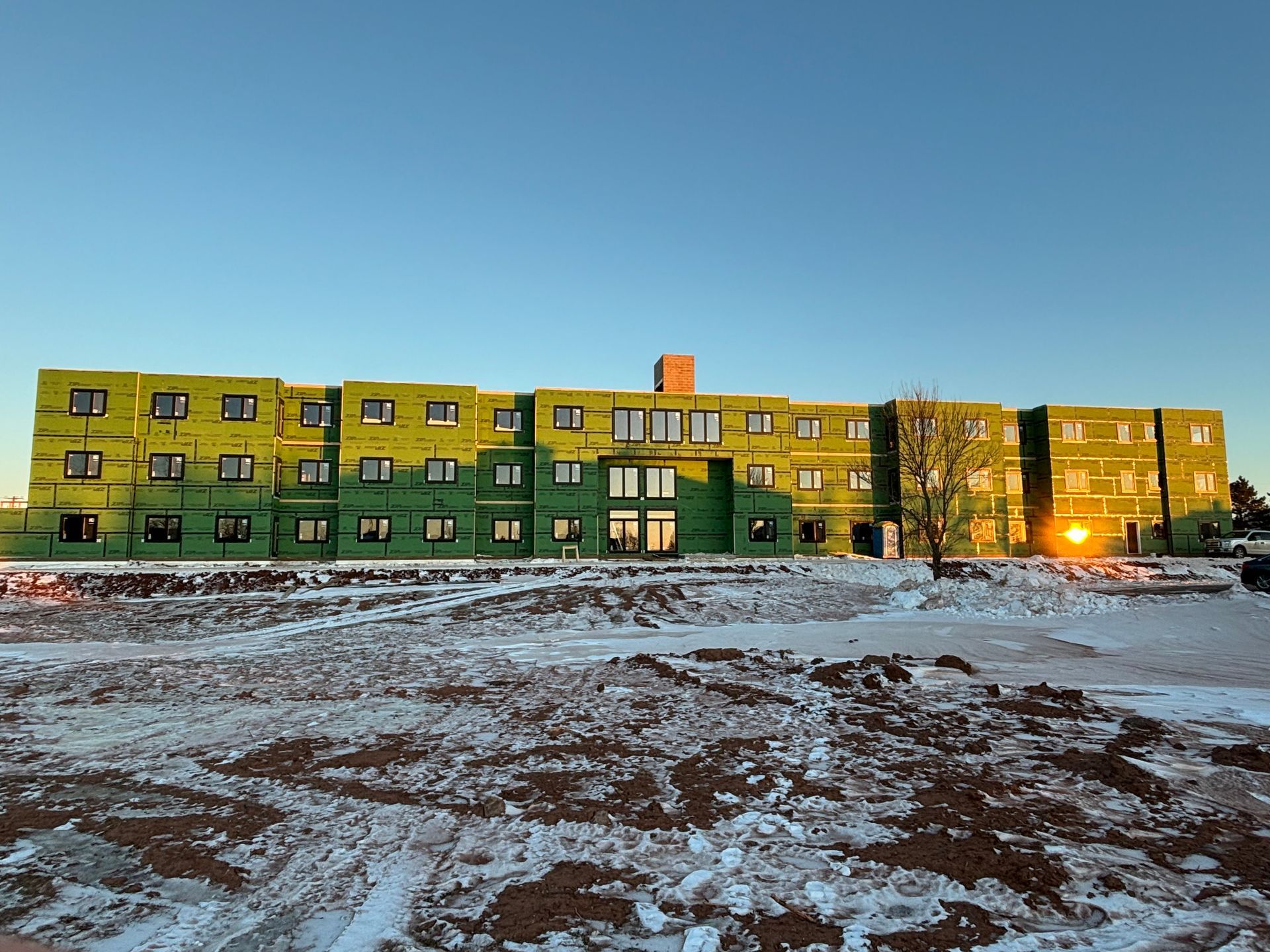 A large green and yellow building with a lot of windows