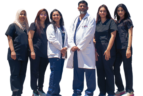 a group of doctors and nurses are posing for a picture .