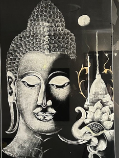 Buddha's face, half in light, with a stupa and moon in a black background.