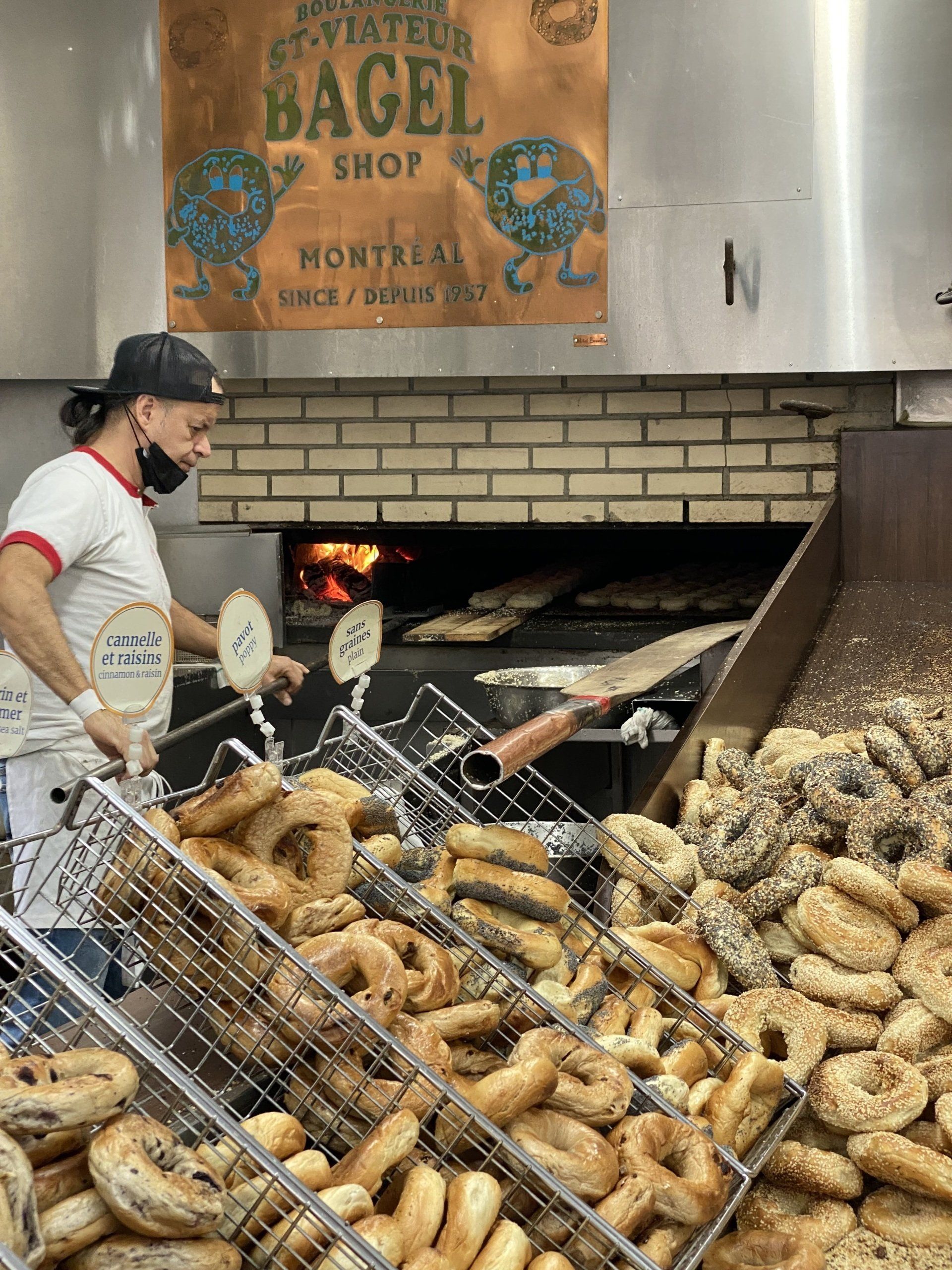 A man is making bagels in a bakery.