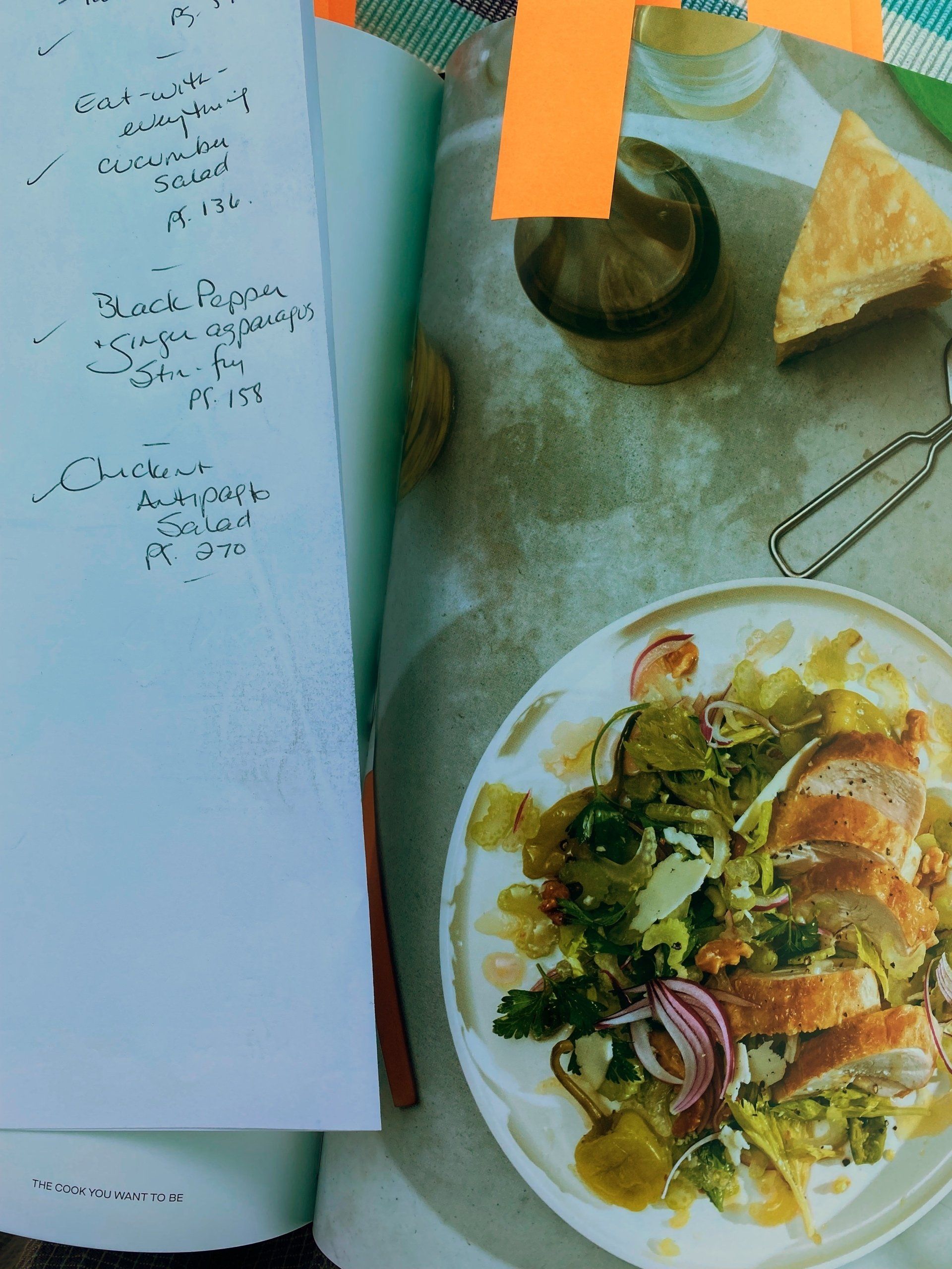 A book is open to a page with a picture of a plate of food