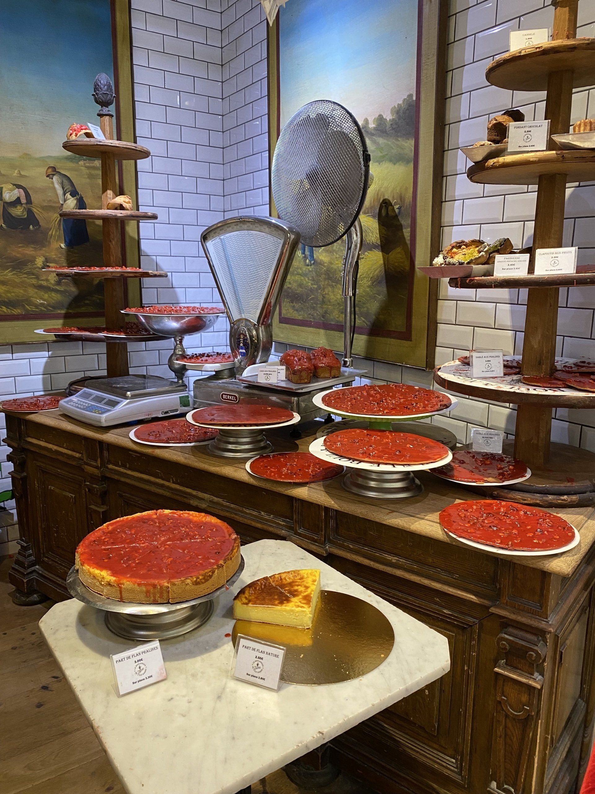 A display of pies on a table in a bakery.