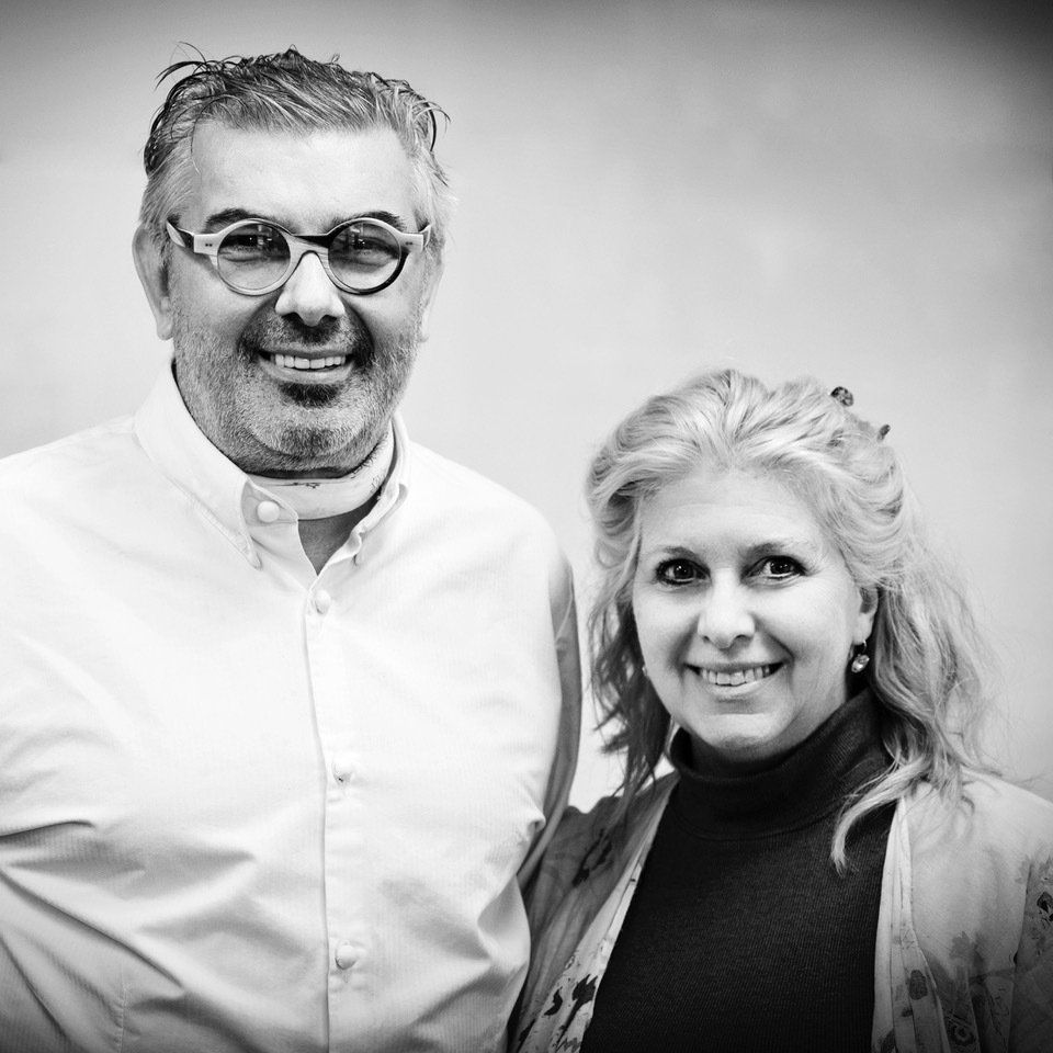 A man and a woman are posing for a black and white photo.