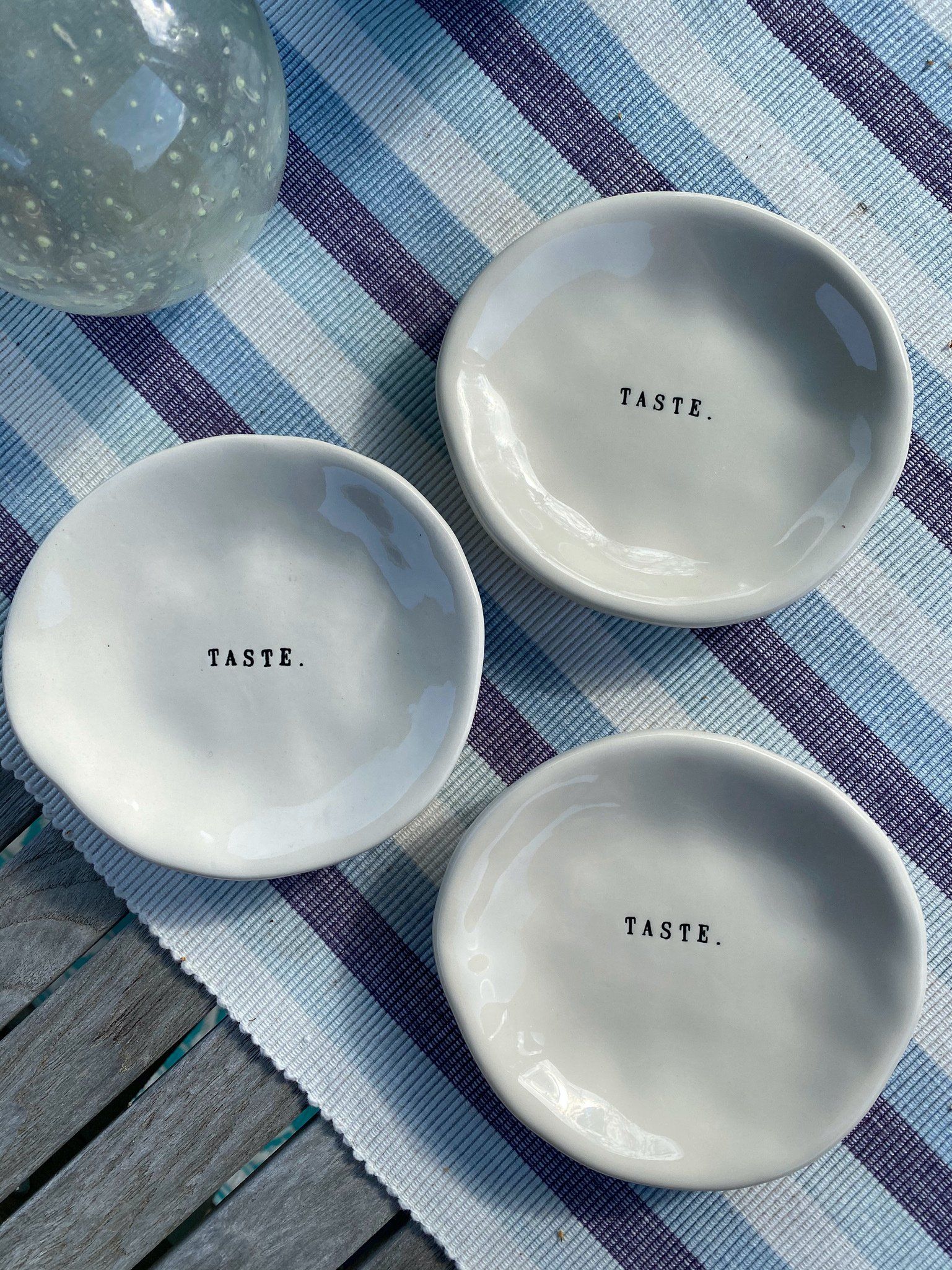 Two white plates with the word taste written on them