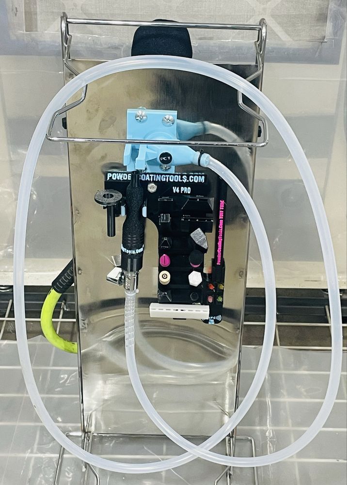 Stainless steel device with tubing in a wire cage, containing water.