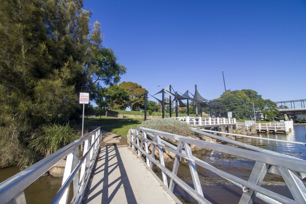 A Bridge Over A Body Of Water With Trees — Jervis Bay Pressure Washing & Property Maintenance In Bomaderry, NSW