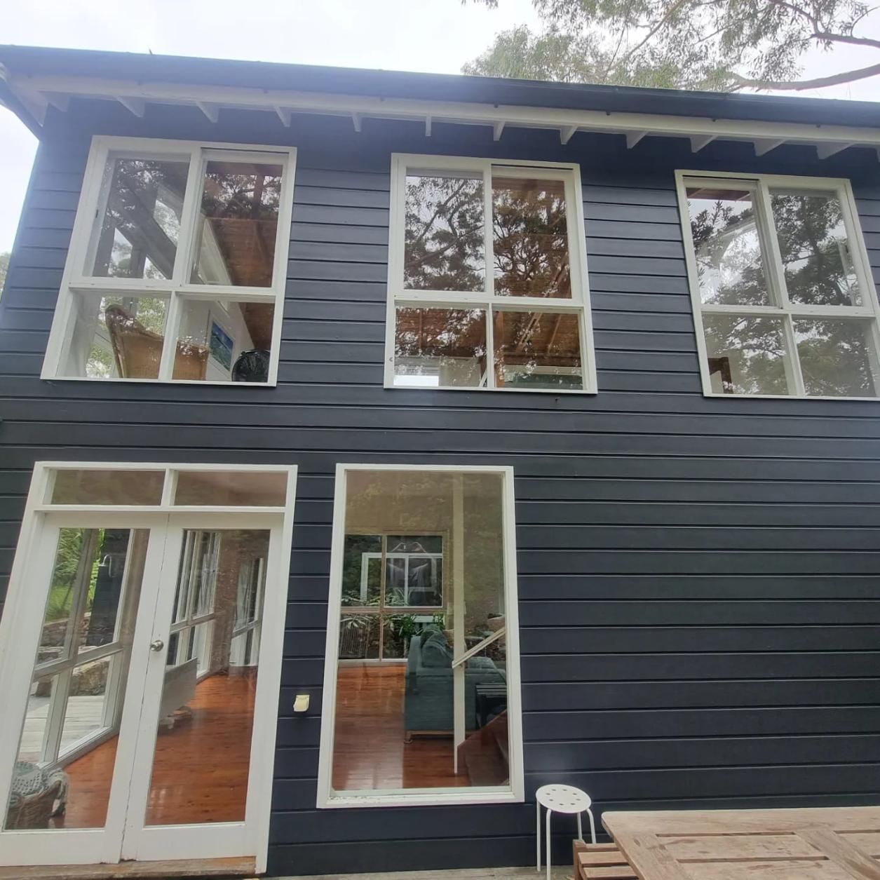 A Black House With Lots Of Windows And Doors — Jervis Bay Pressure Washing & Property Maintenance In Culburra, NSW