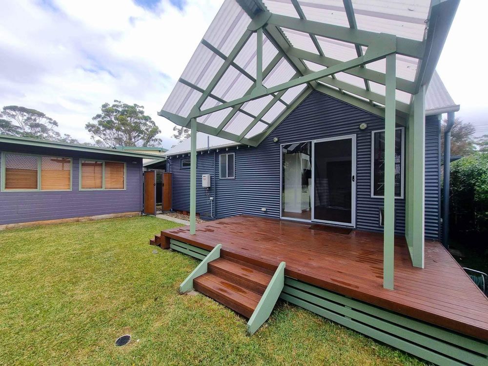House With A New Wooden Deck And Stairs Cleaning — Jervis Bay Pressure Washing & Property Maintenance in Sanctuary Point, NSW