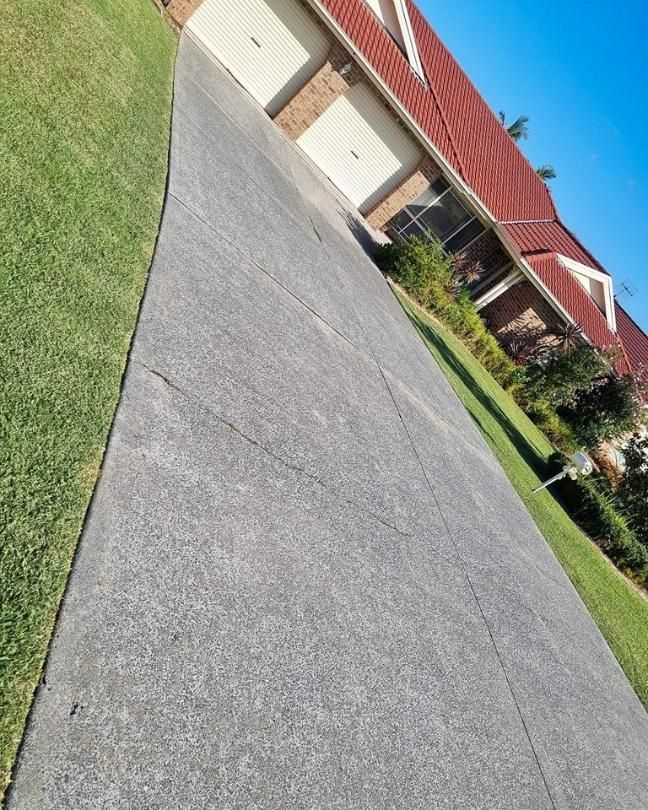 A Driveway Leading To A House With A Red Roof — Jervis Bay Pressure Washing & Property Maintenance In Bowral, NSW