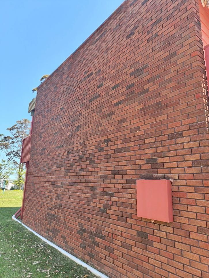 A Newly Cleaned Red Brick Wall With A Red Box — Jervis Bay Pressure Washing & Property Maintenance in Sanctuary Point, NSW