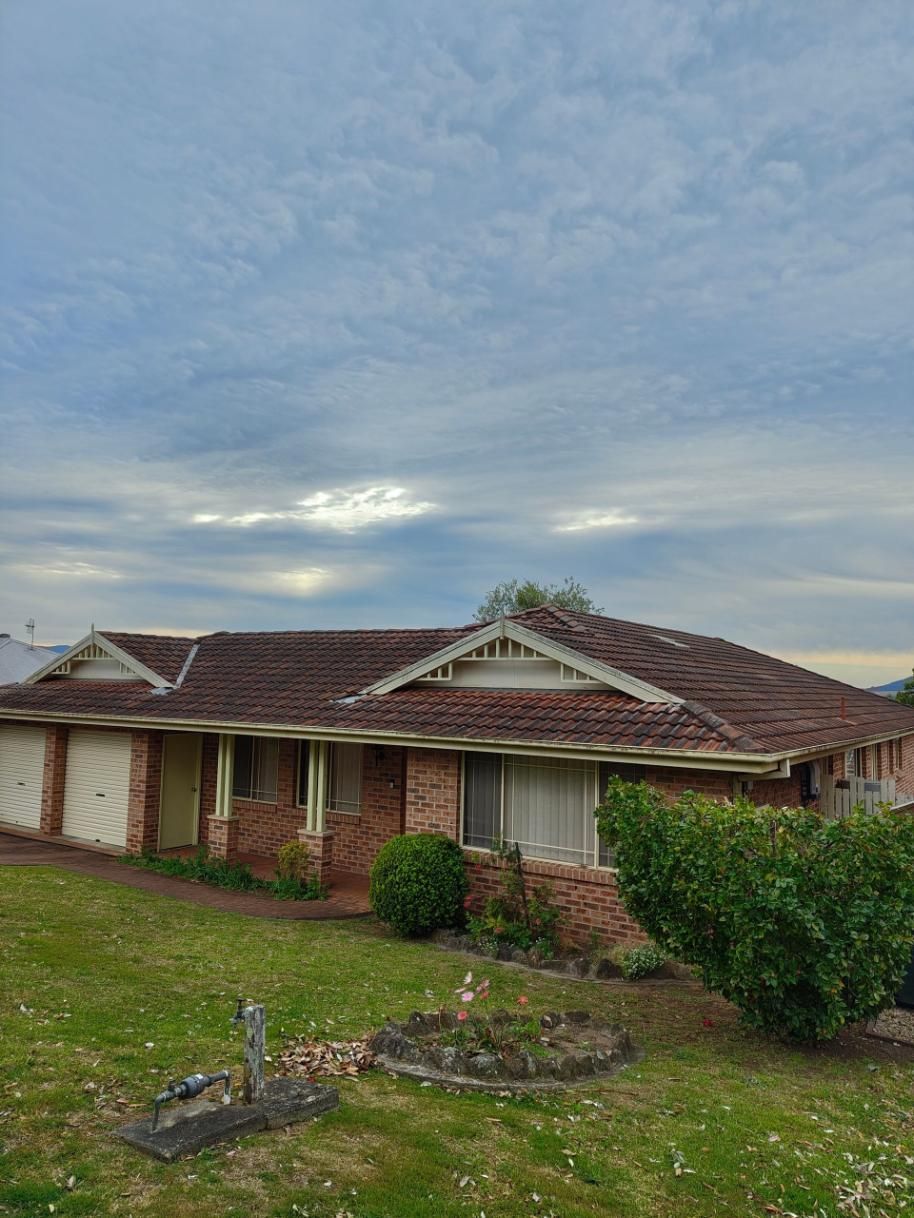 A Brick House With A Dirty Tiled Roof — Jervis Bay Pressure Washing & Property Maintenance in Sanctuary Point, NSW