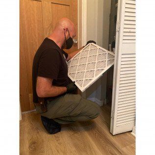 Man Checking AC Filter — Lithia, Fl — JS Watson Air