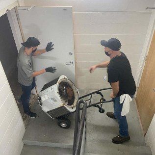 Two Man Carrying Aircon Downstairs — Lithia, Fl — JS Watson Air