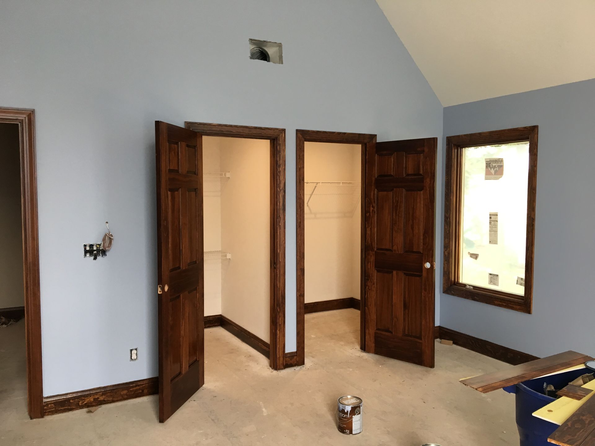 Kitchen with brown cabinets, stainless steel appliances, and white countertops.