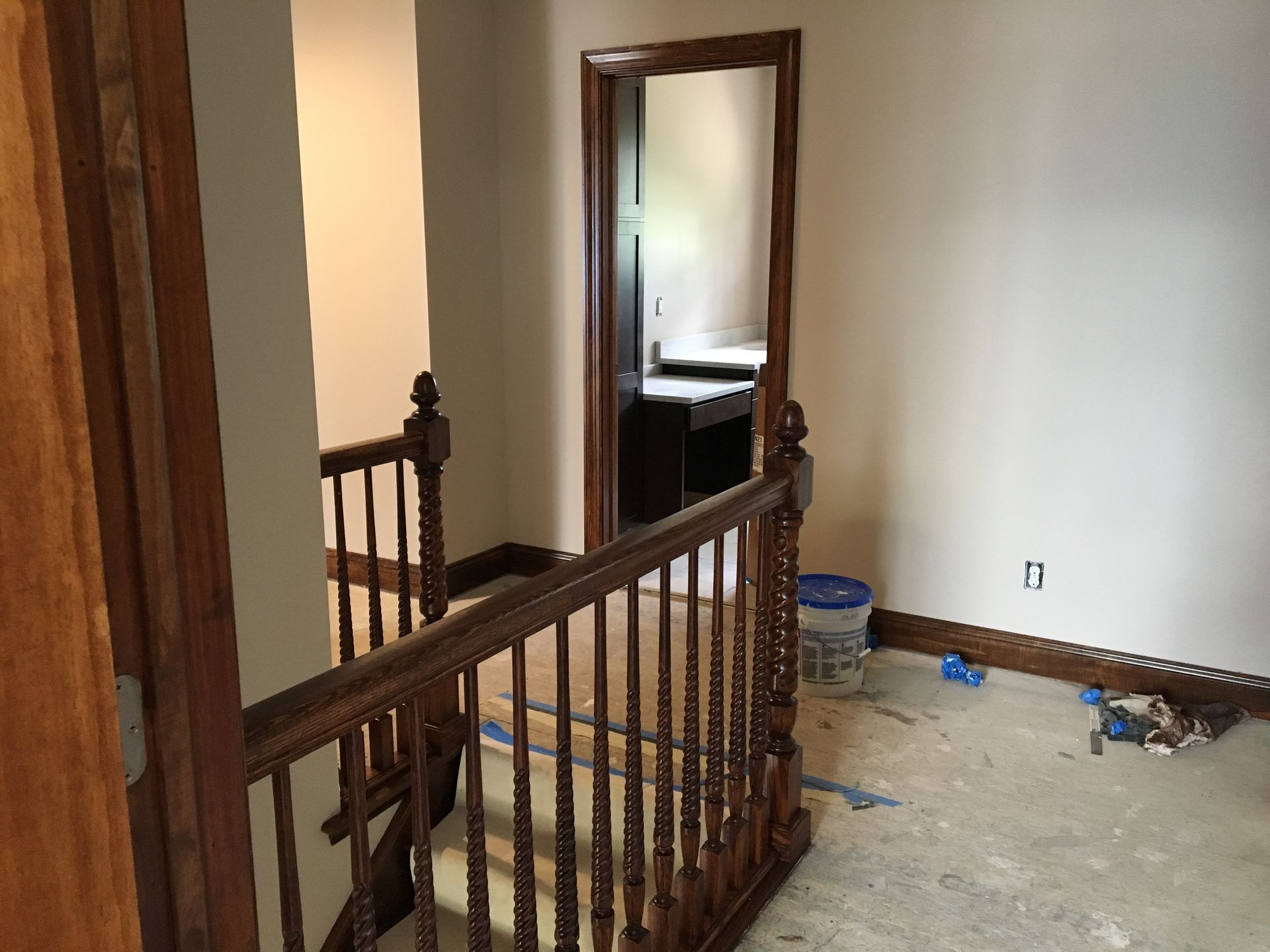 Bathroom with yellow walls, brown vanity, white toilet, and tiled shower.