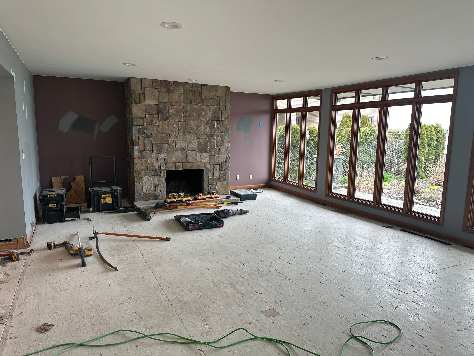 Unfinished basement with concrete walls, exposed wooden beams, and a concrete floor.