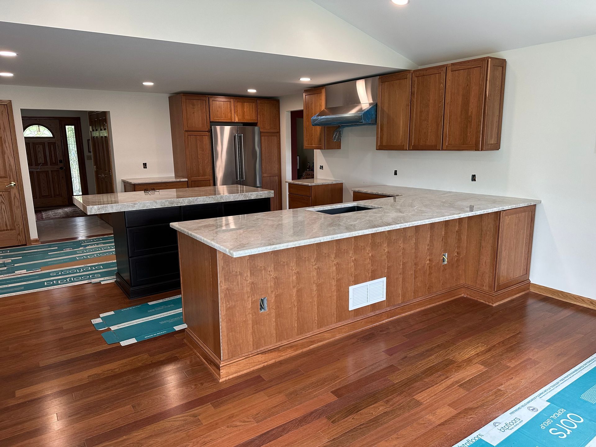 Gray kitchen with stainless steel appliances, cabinets, and a white countertop.