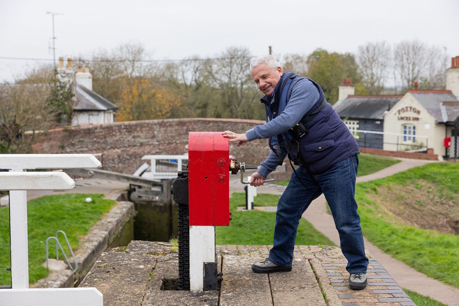 A man is operating a windlass at Foxton Locks.