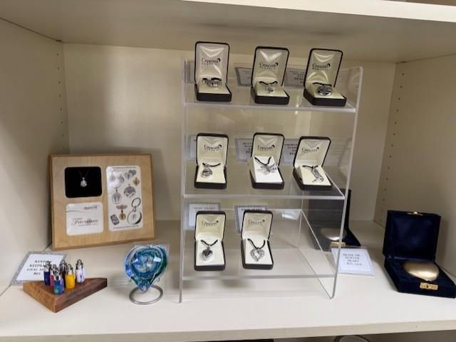Display case of jewelry and decorative items on shelves and a tabletop