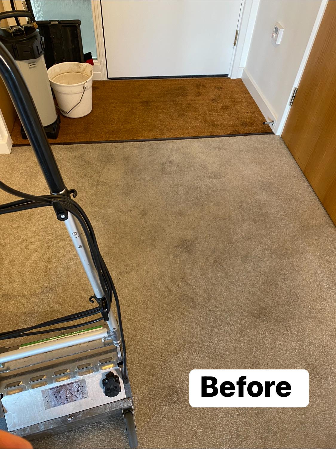 a vacuum cleaner is sitting on a dirty carpet in a room .