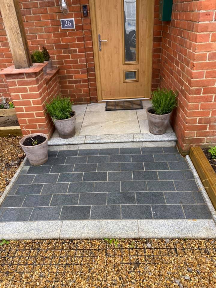 there are potted plants on the sidewalk in front of the door. after cleaning .