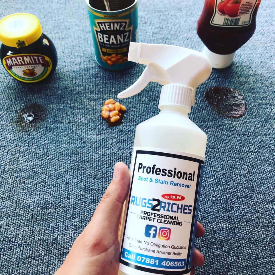 a person is holding a bottle of professional rug cleaner