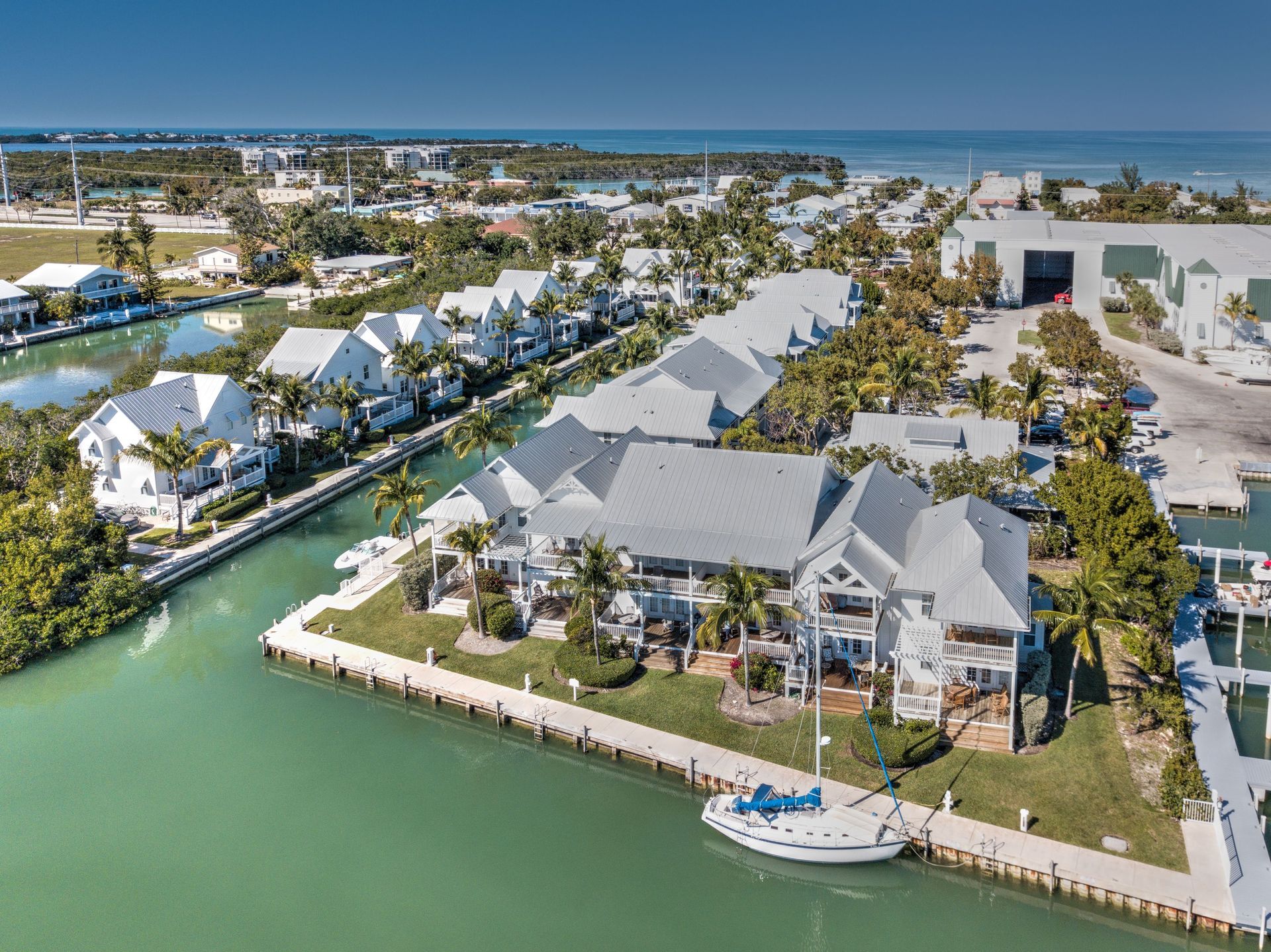 An aerial view of a residential area with a boat docked in the water.