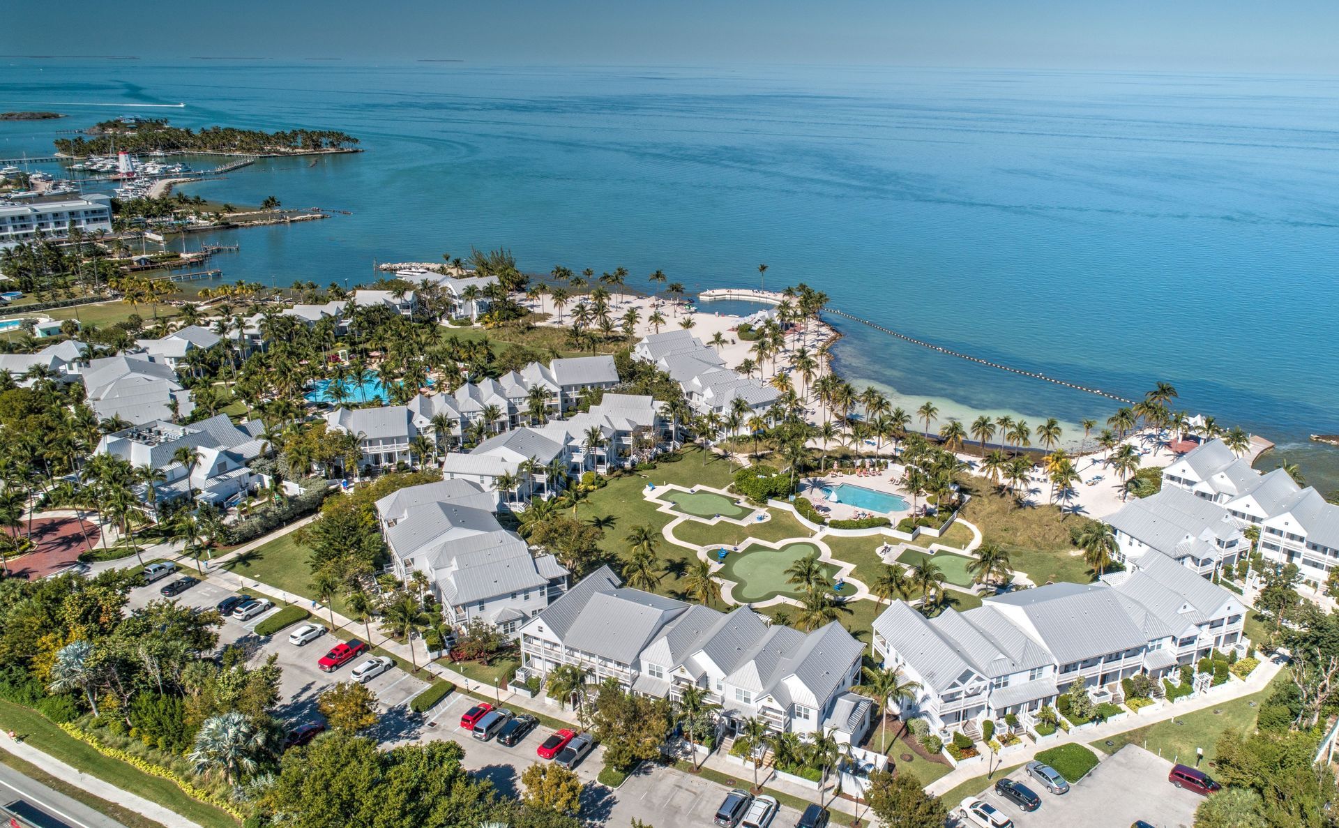 An aerial view of a resort surrounded by water and buildings.