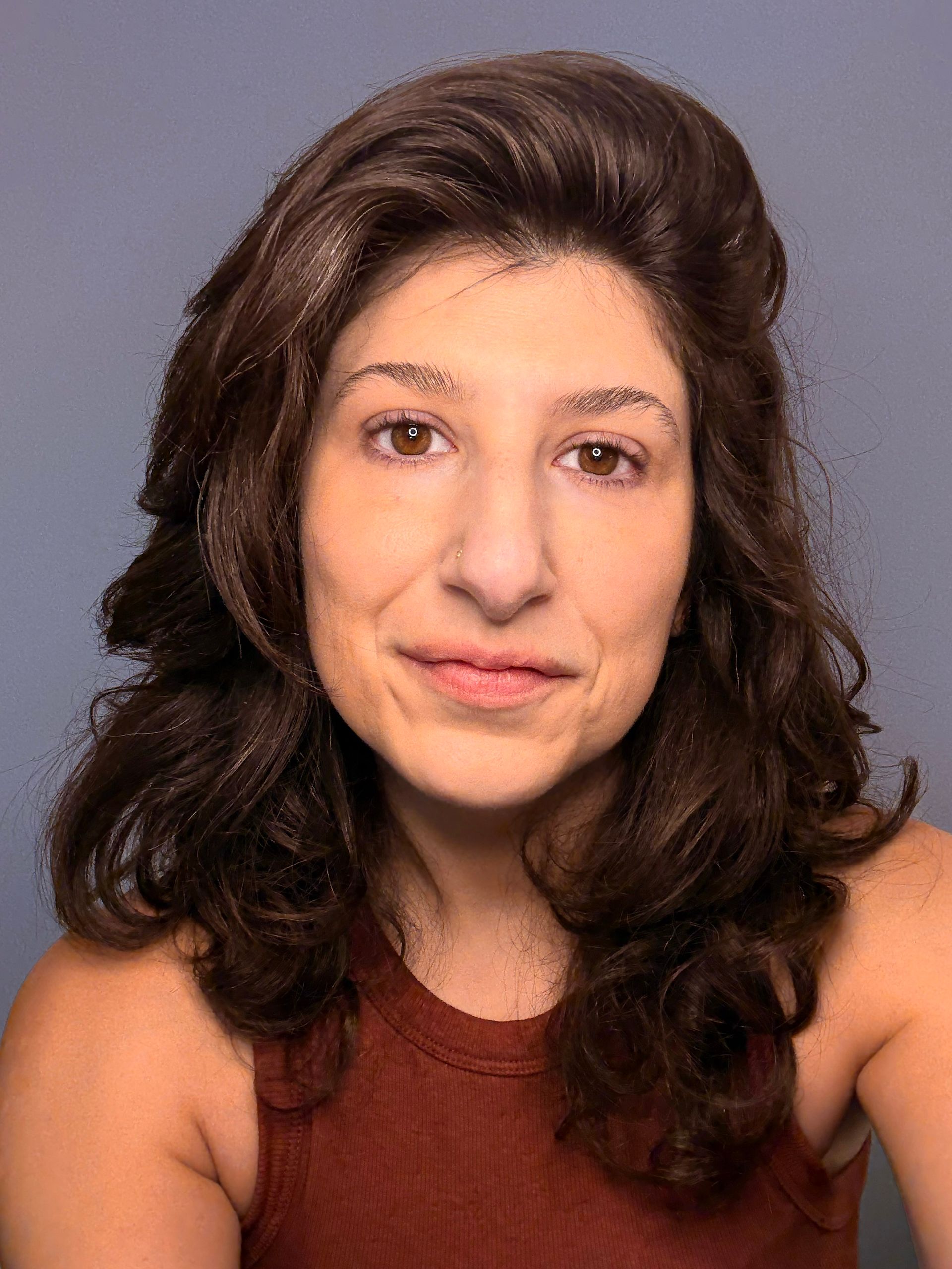 Headshot of cristina against a purple background.