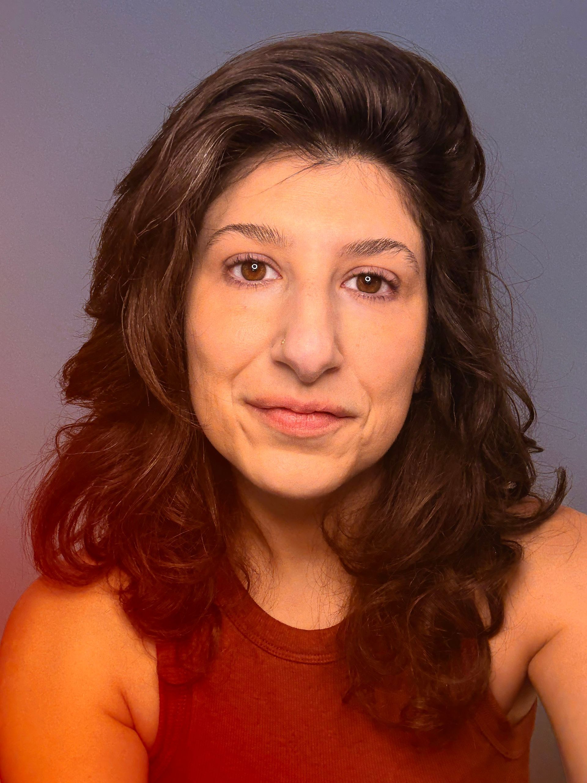 Headshot of cristina against a purple background.