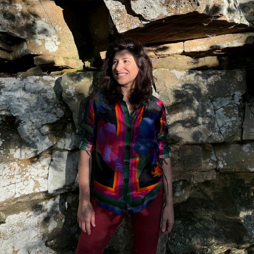 Image of Cristina outside looking to the left smiling