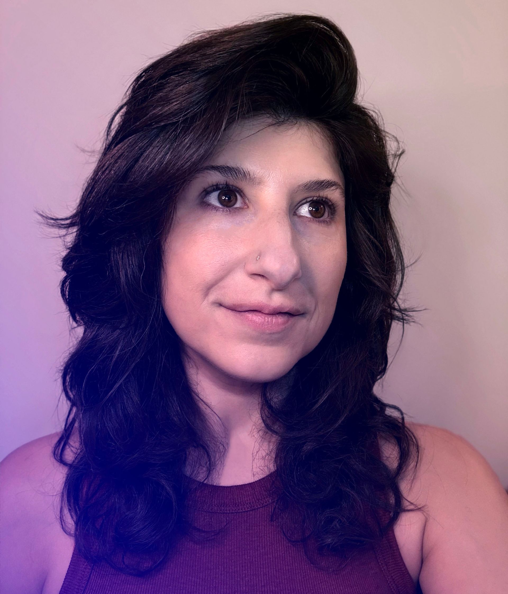Headshot of Cristina Maria Fort Garces on a purple background.
