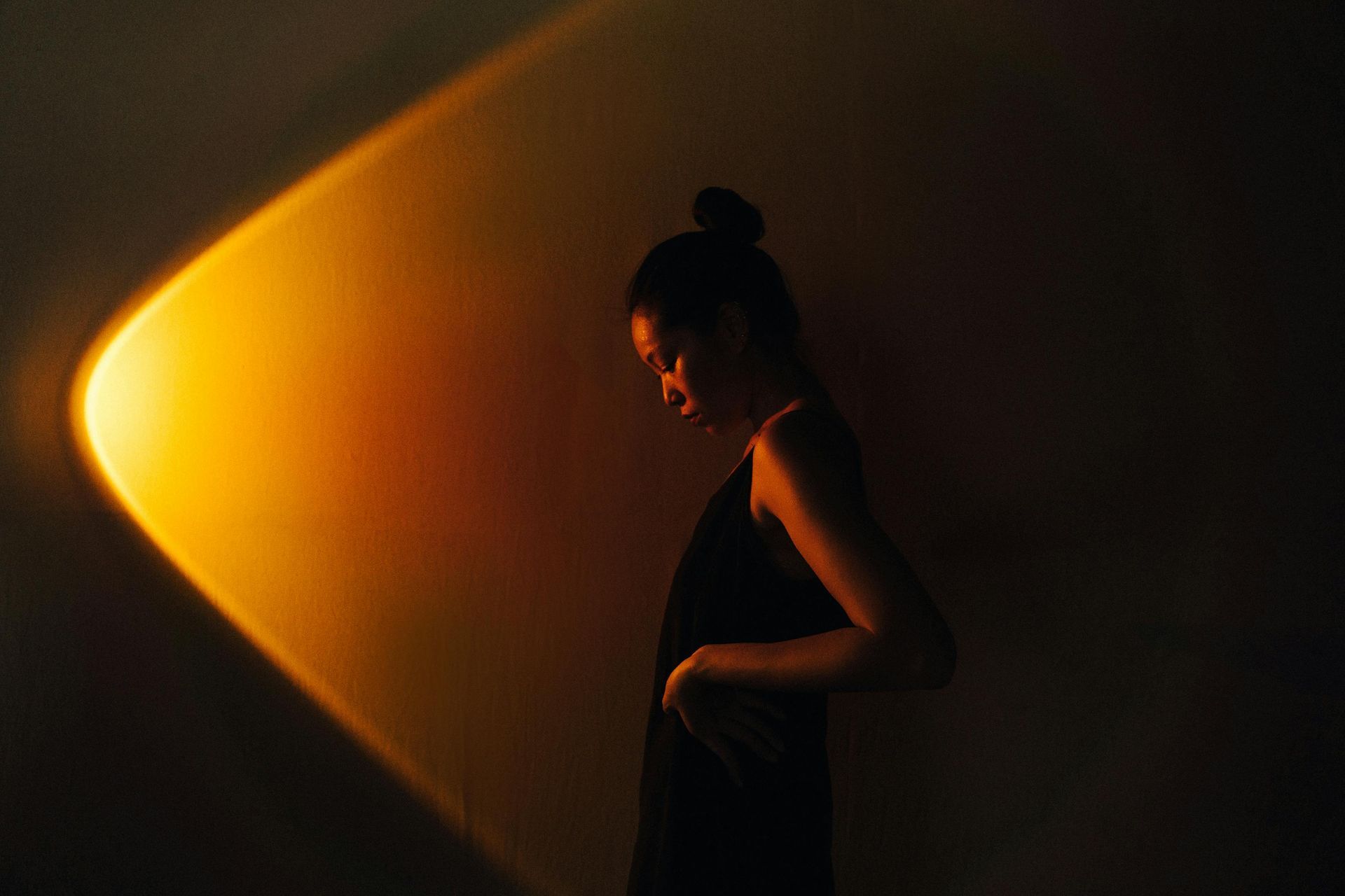 Image of a woman standing in front of a light. 