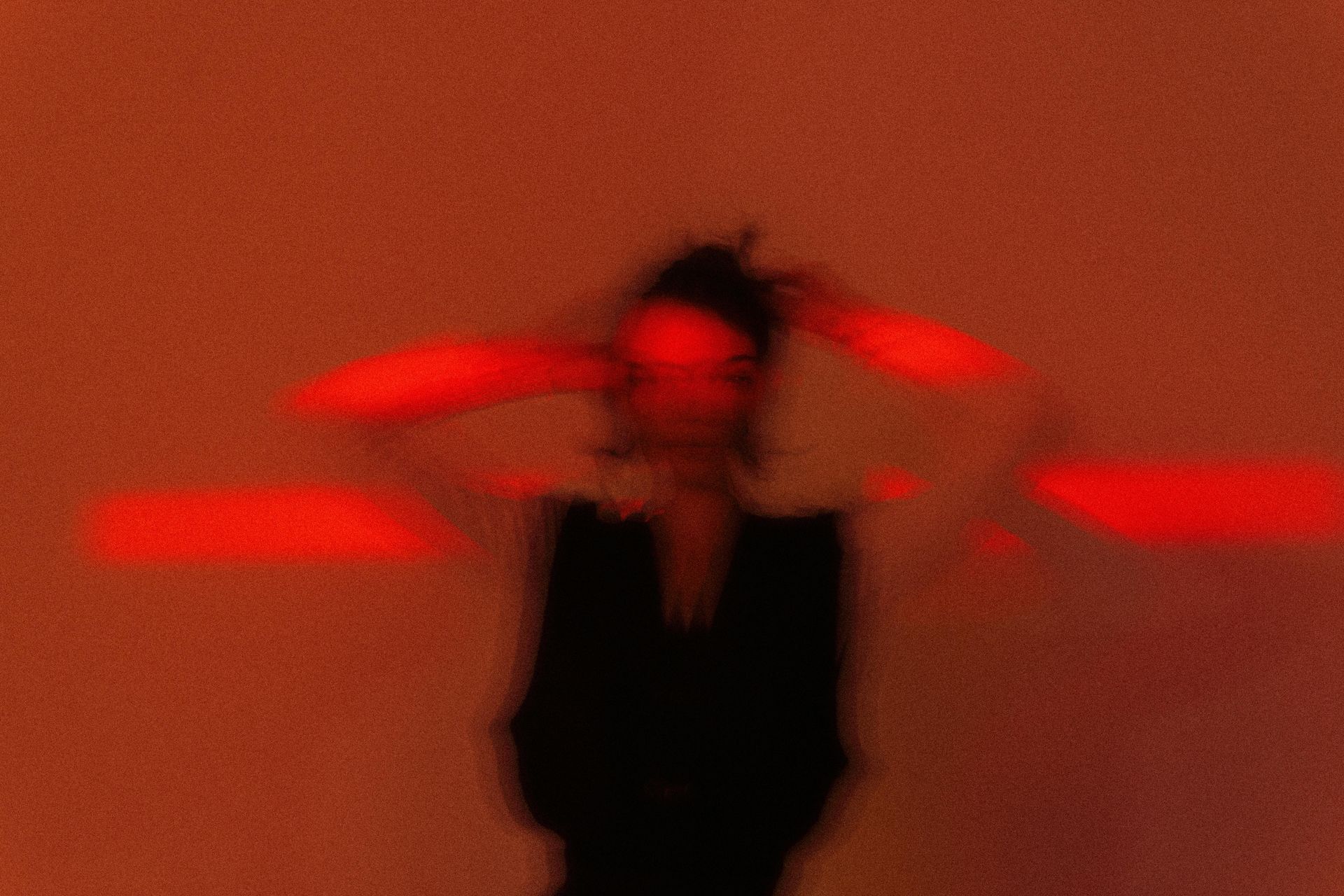 Energy healing techniques. Woman against a red background.
