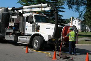 Man Working on a White Truck – Kalamazoo, MI – Clean Earth Environmental Contracting Services