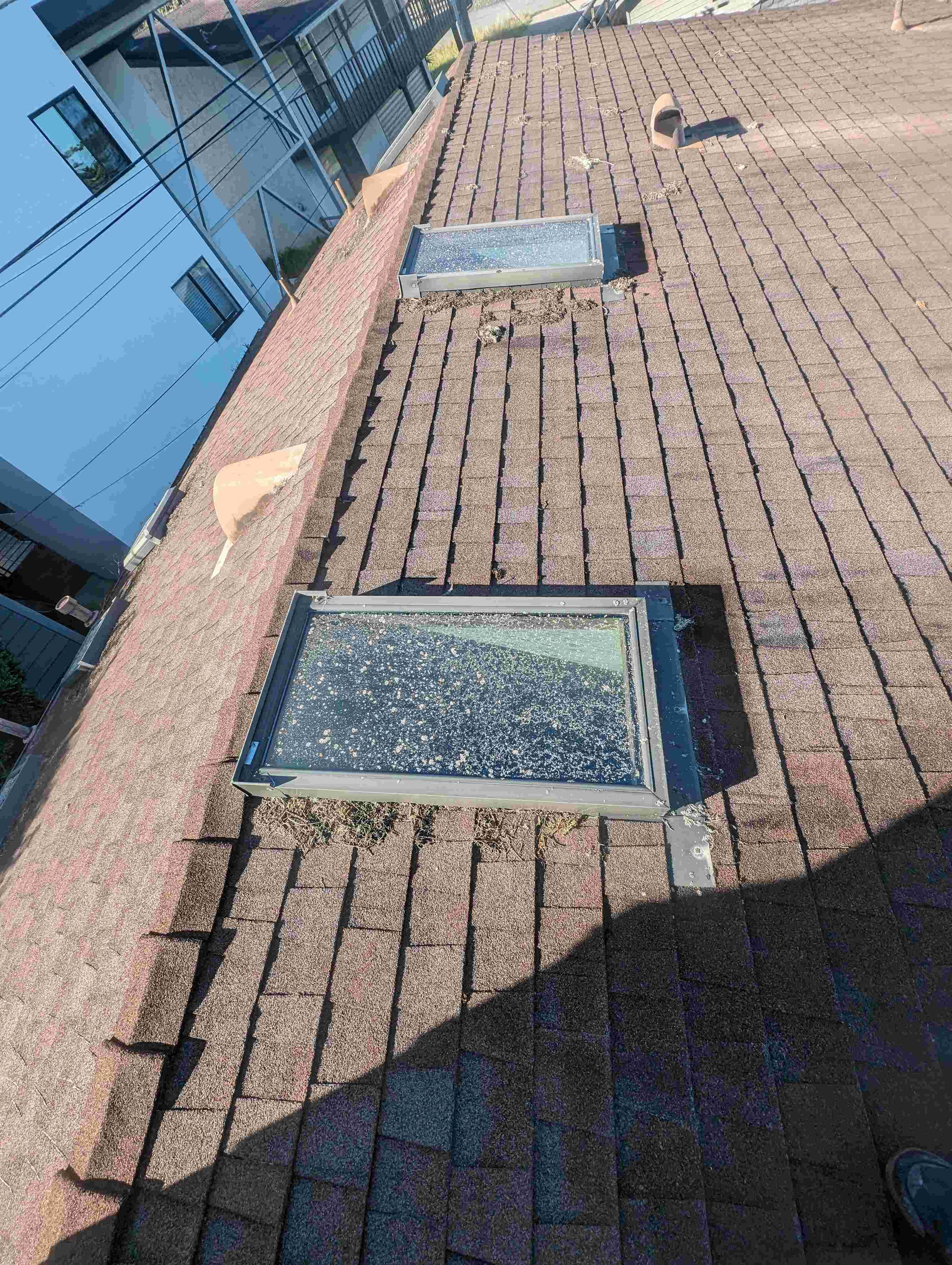 There are two skylights on the roof of a building.