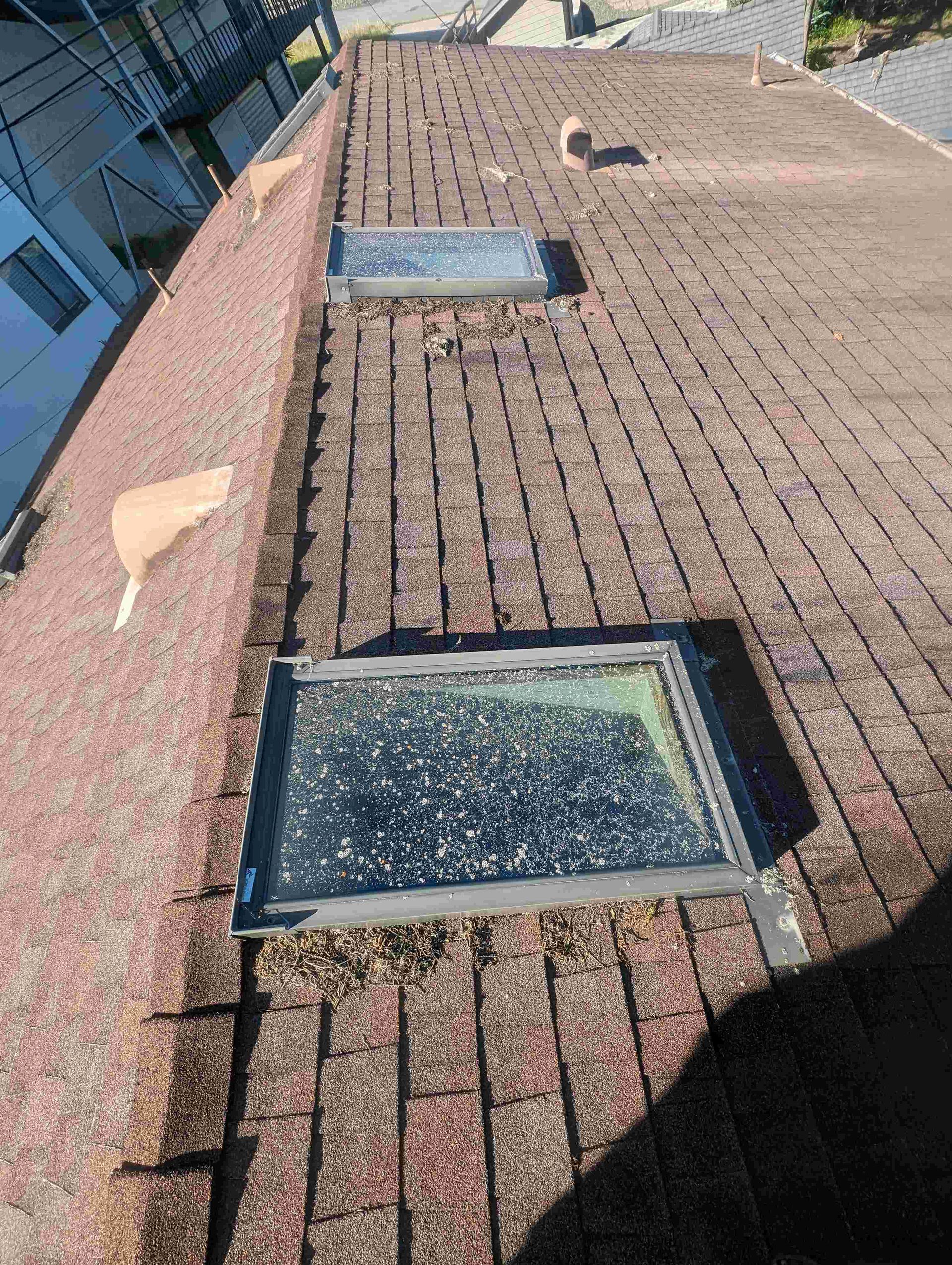 There are two skylights on the roof of a building.