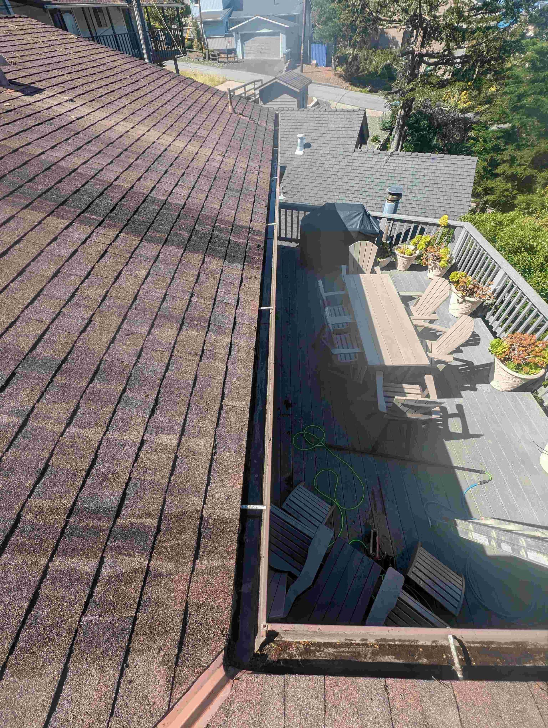 Aerial view of a roof with a gutter and a deck.