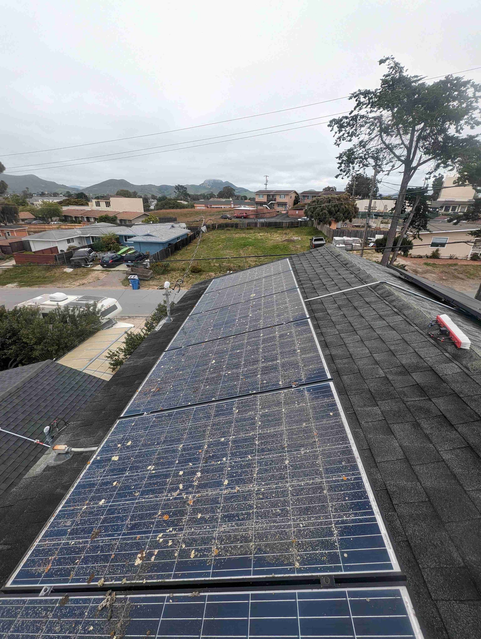Row of solar panels are sitting on top of a roof.