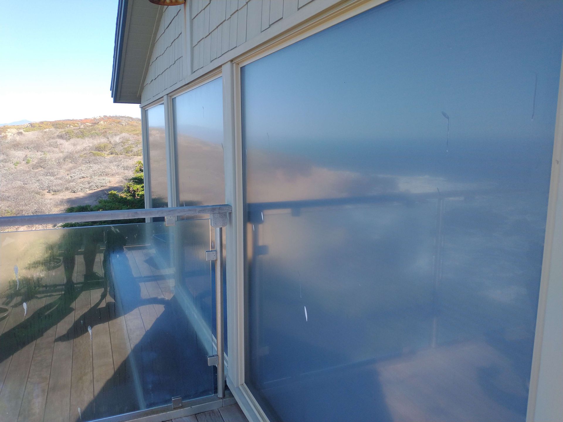 Large window on the side of a building with a view of the ocean.